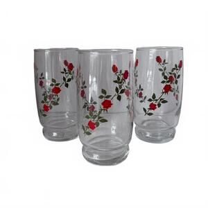 Set of 3 vintage Anchor Hocking glass tumblers with red rose pattern.